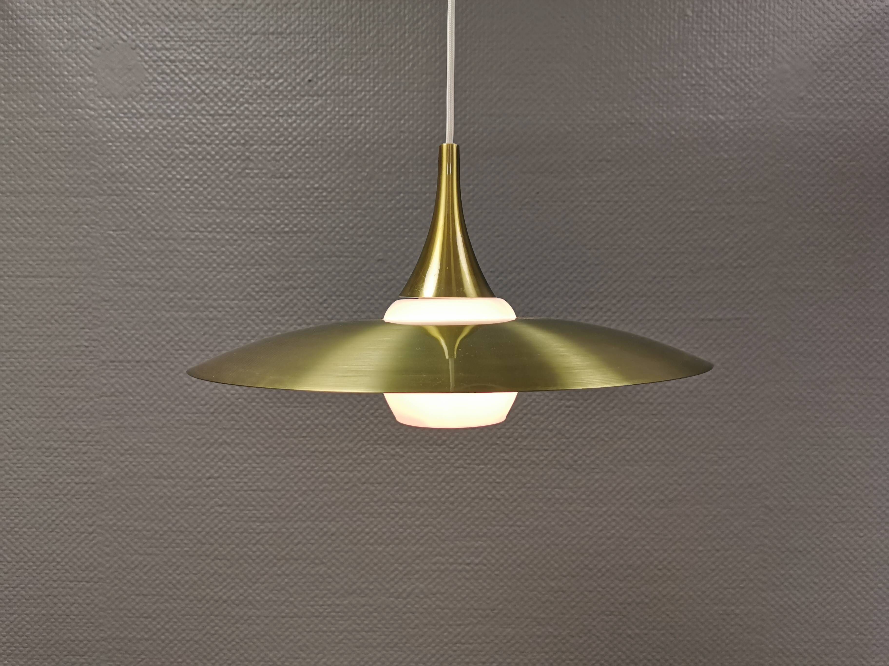 Hanging lamp, from the 1970s in matte white glass and brass colored metal.
