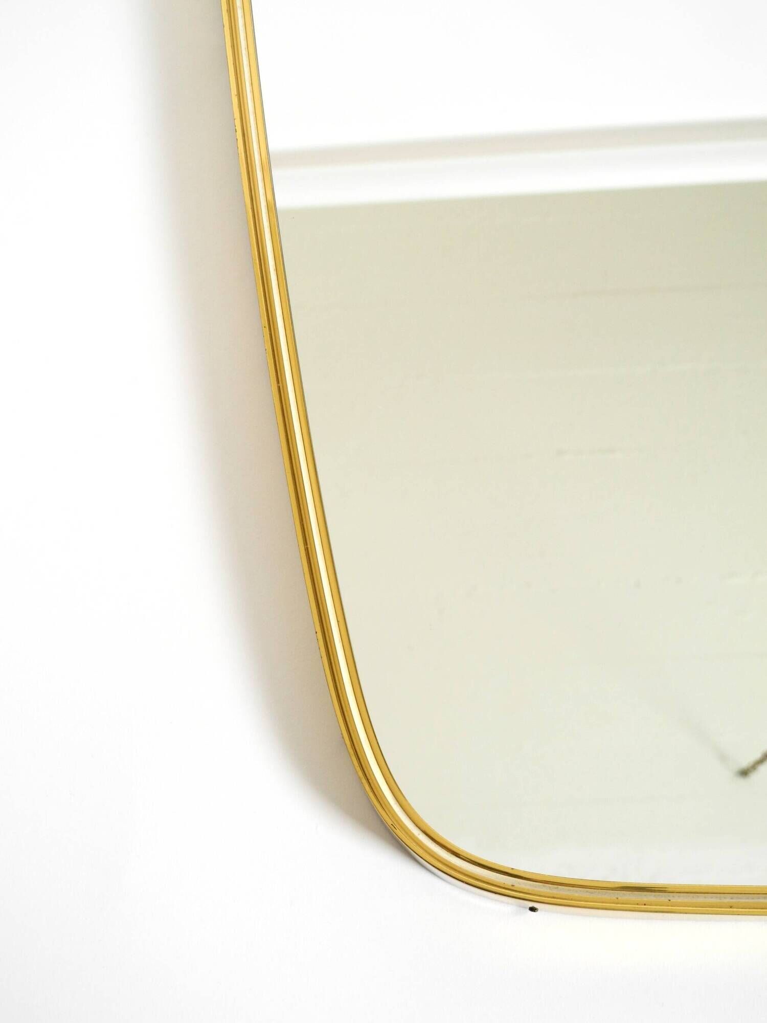 A pair of rare Mid Century "Münchener Zierspiegel" brass wall mirrors