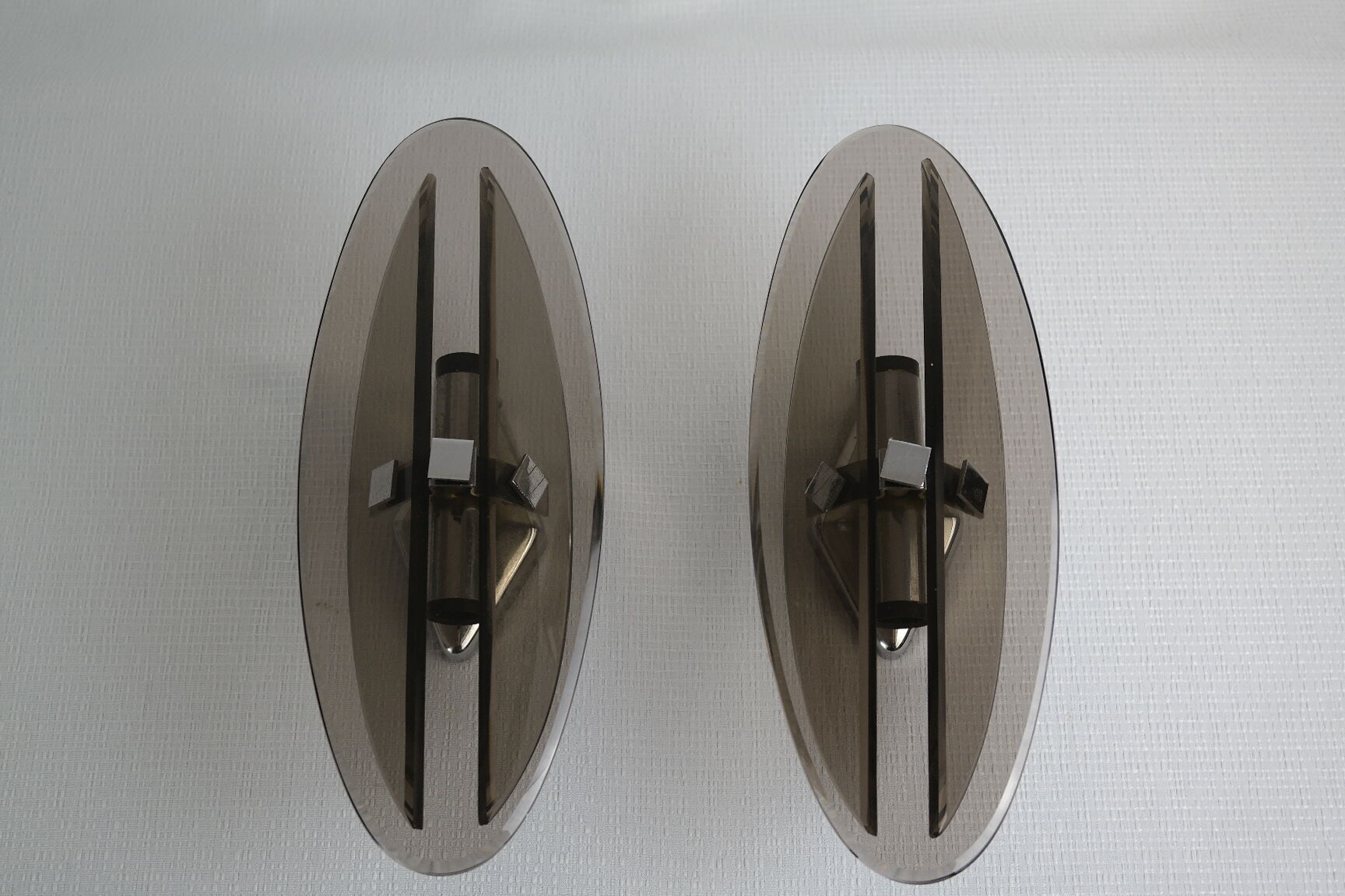 Pair of smoked glass and vintage chrome wall lamps