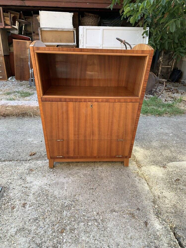 Brown trapezoidal wooden bar cabinet from the 1960s with a niche and lockable flap.