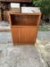 Brown trapezoidal wooden bar cabinet from the 1960s with a niche and lockable flap.