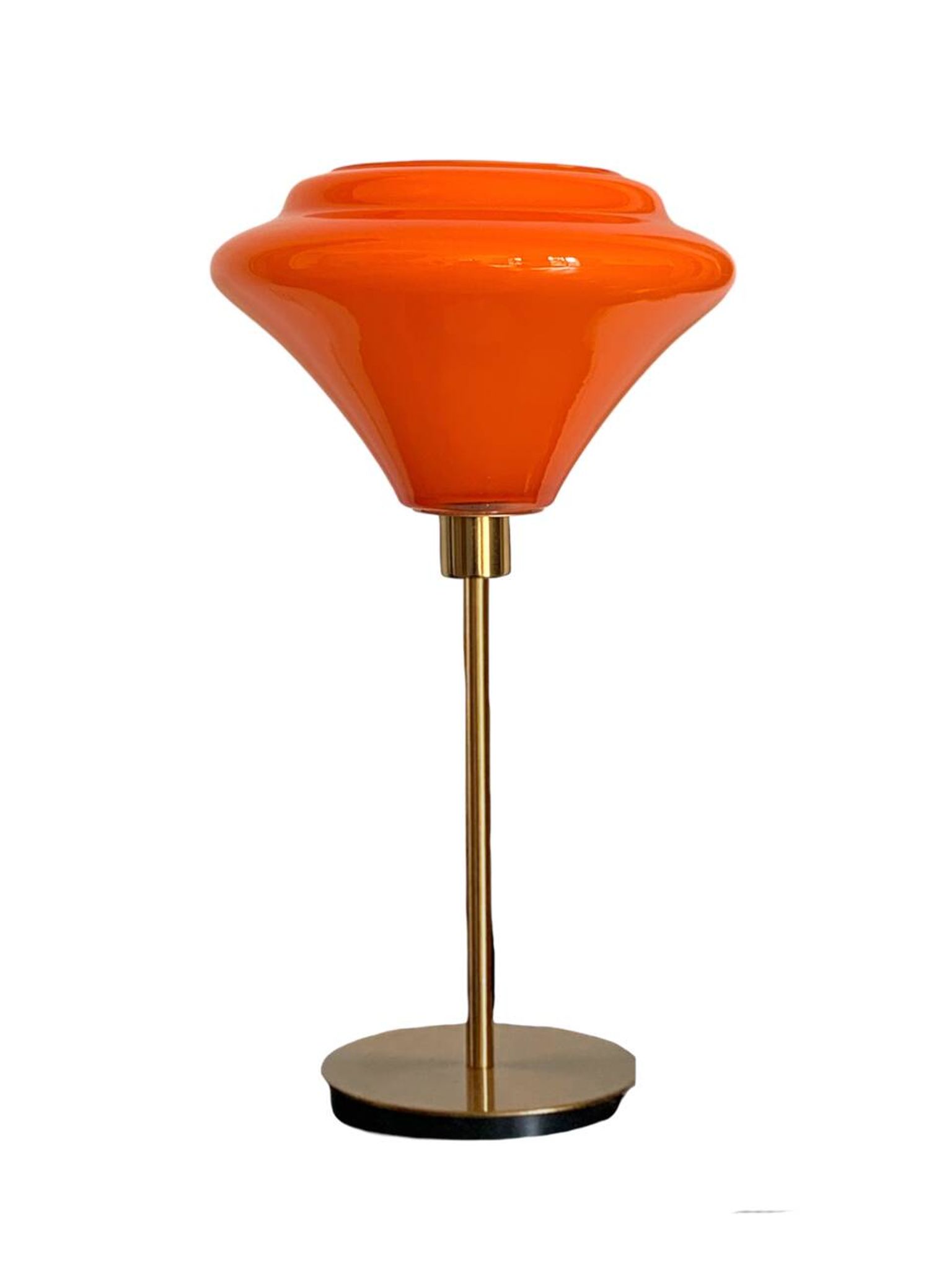 Table lamp with a vintage orange glass globe and a gold base