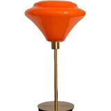Table lamp with a vintage orange glass globe and a gold base
