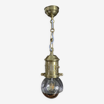 Brass pendant light with oversized LED bulb