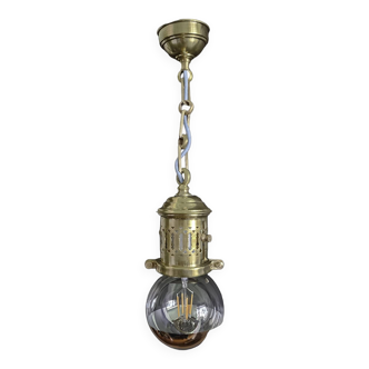 Brass pendant light with oversized LED bulb