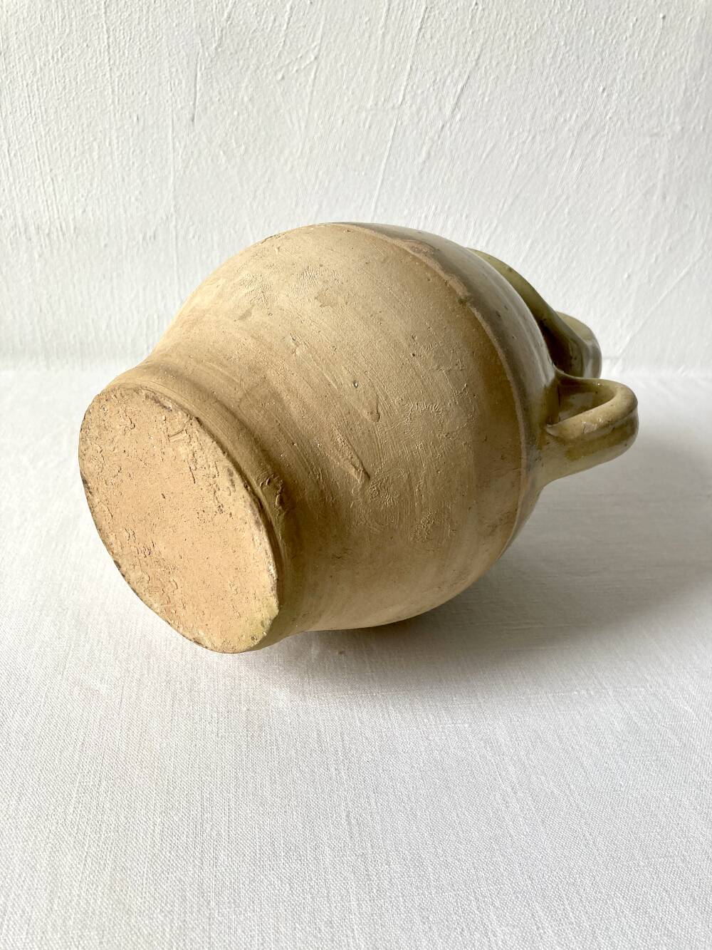 Old small goat-shaped jug in ochre glazed stoneware.