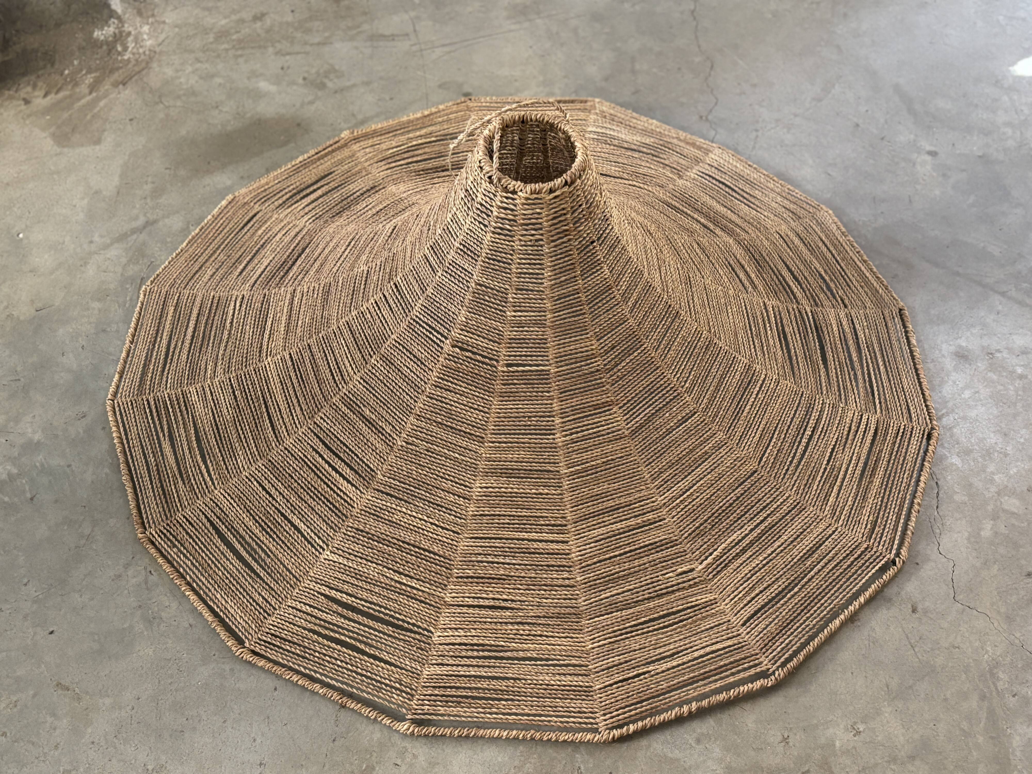 Large lampshade made of woven ropes.