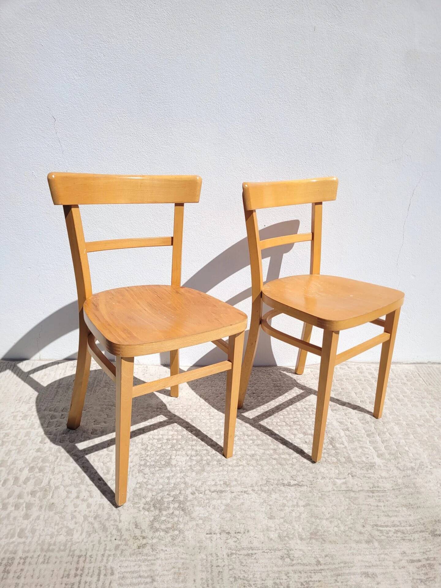Pair of bistro chairs in light beech.