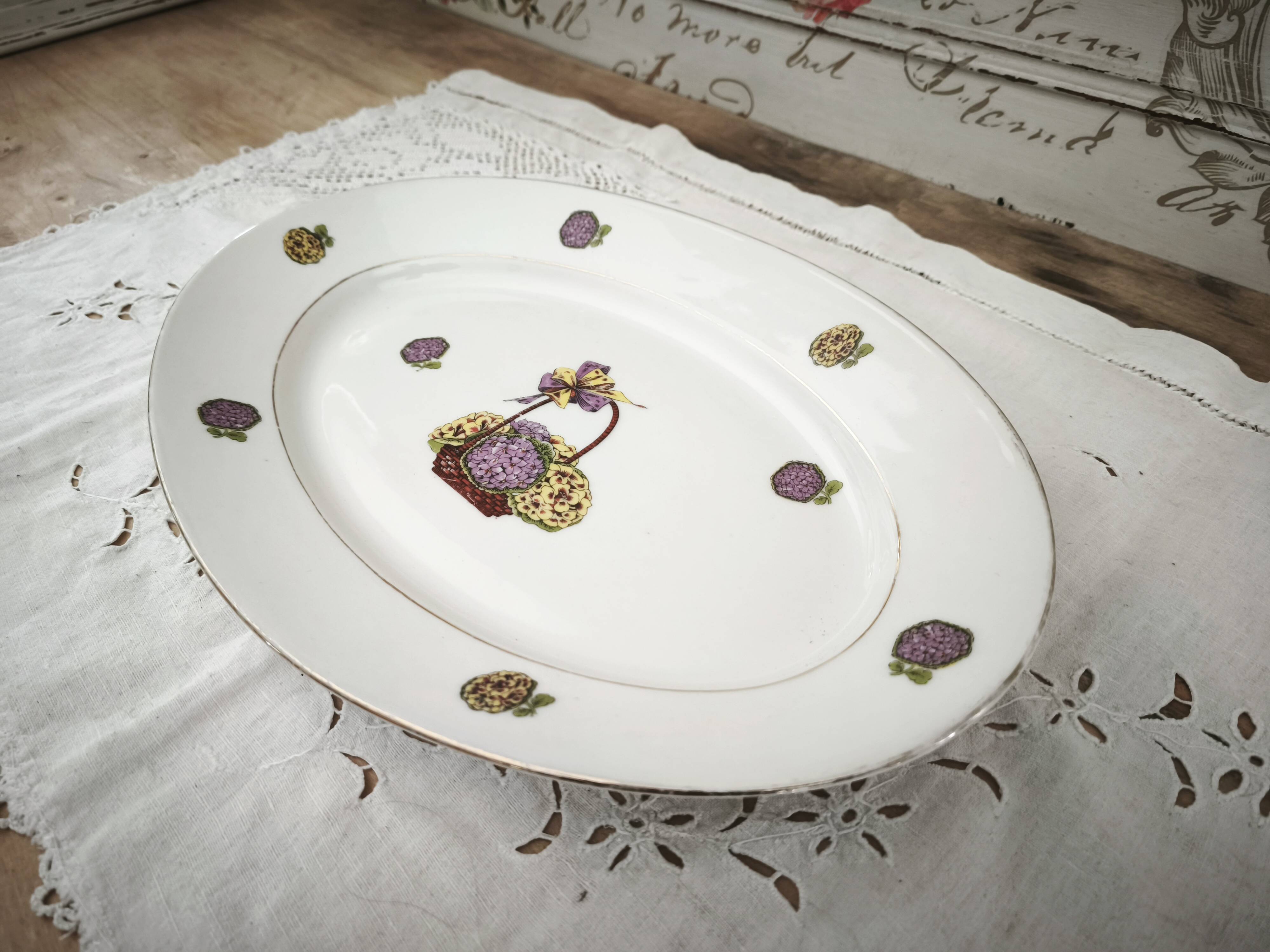 Oval porcelain plate from Limoges with a hydrangea basket design.