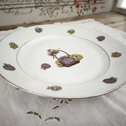 Round porcelain plate from Limoges with a hydrangea basket design.