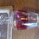 Service a liqueur composé d'une carafe en verre rouge, de 6 verres momie et d'un petit plateau en verre avec des bouquets de fleurs peintes a la main vintage 1950