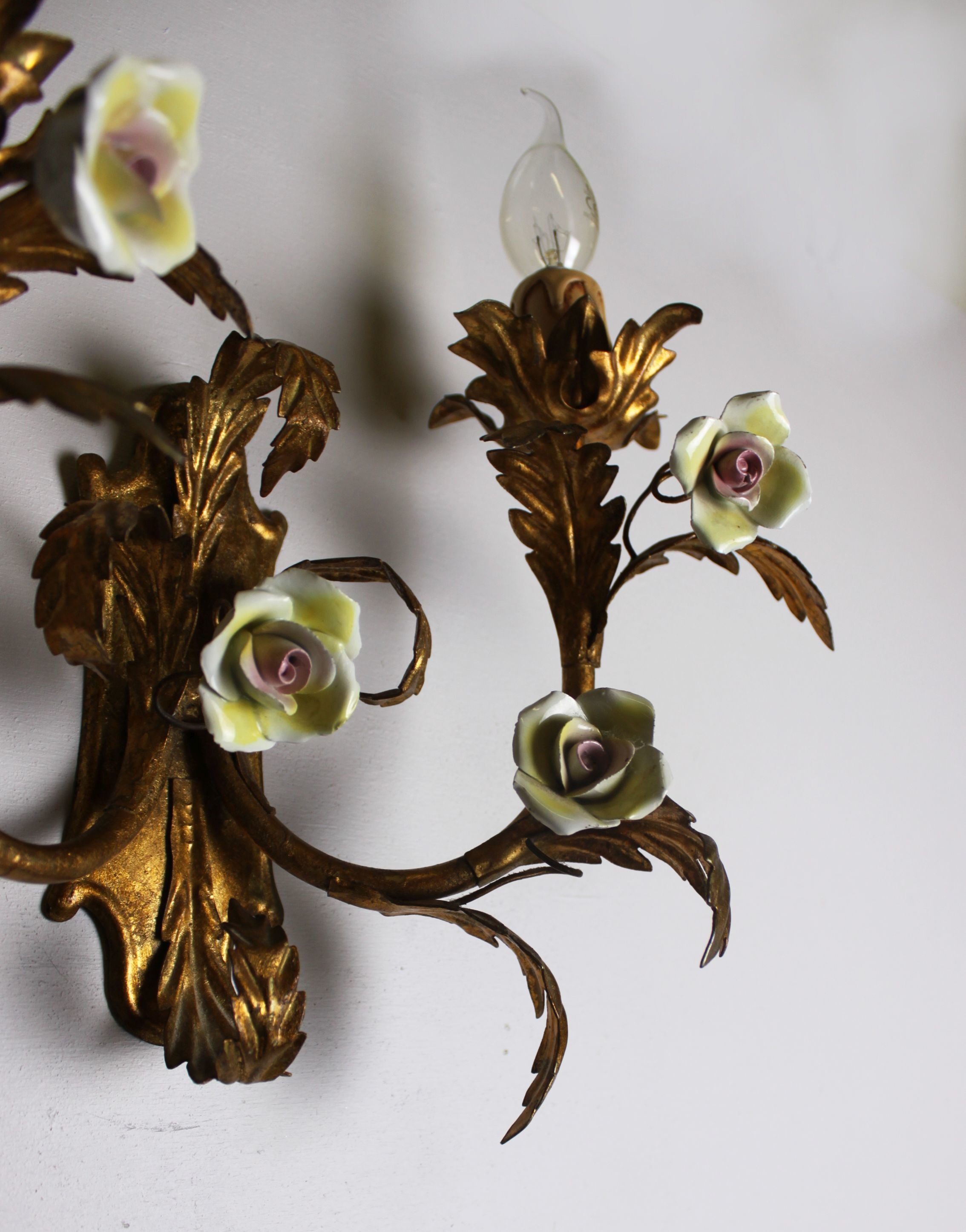 Pair of gold wall sconces with porcelain flowers