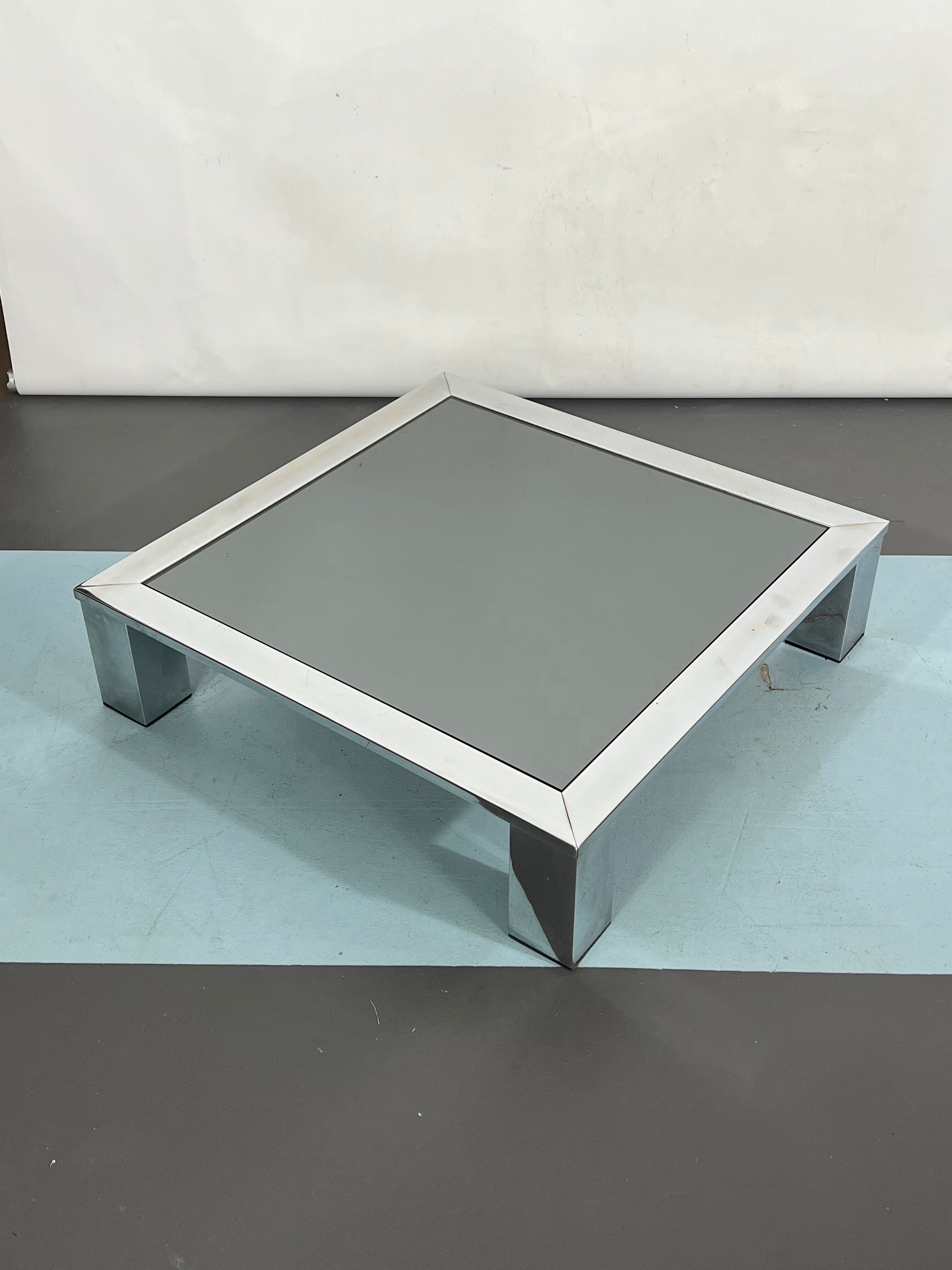 Mid-century chrome and dark mirror glass side table attributed to Saporiti. Italy 1970s
