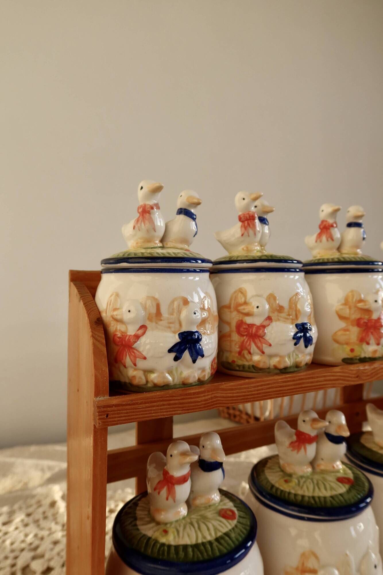 Vintage wooden wall condiment shelf and porcelain pots with geese slip pattern