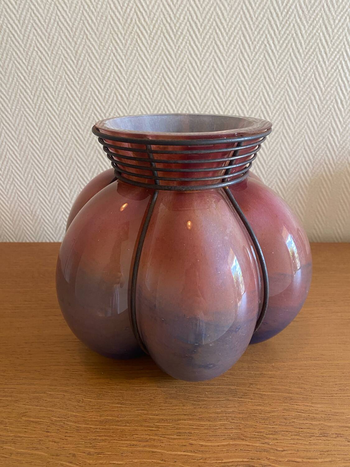 Blown glass vase with metal cage