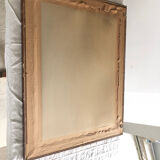 Old mirror with wooden frame and plaster moldings