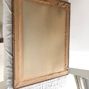 Old mirror with wooden frame and plaster moldings