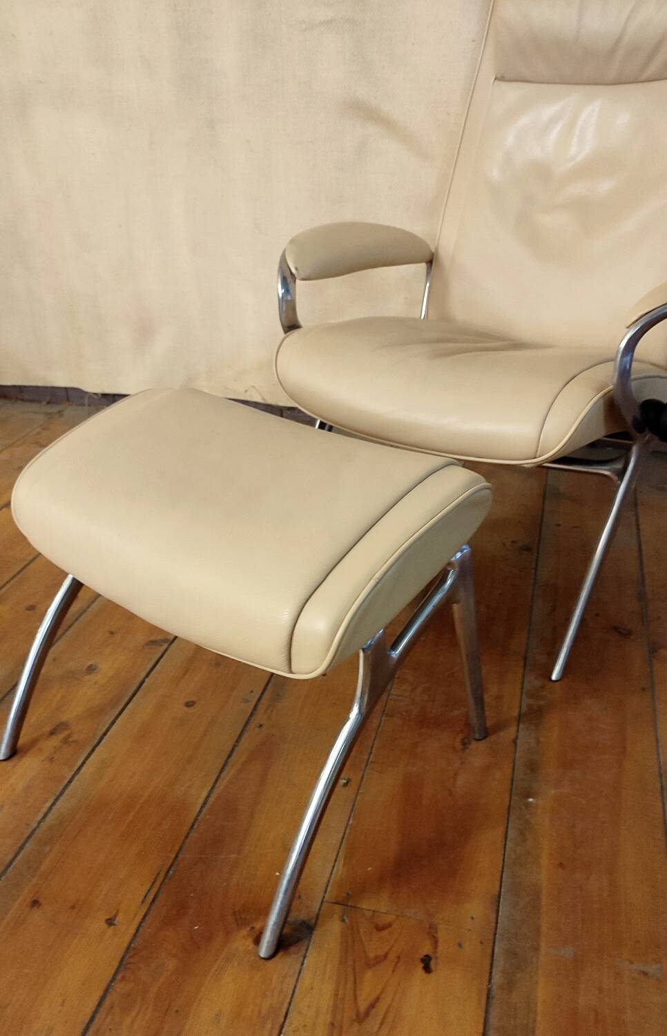 Beige leather armchair and footstool