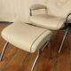 Beige leather armchair and footstool
