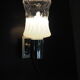 Transparent and white glass torch-type wall light.