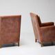 Pair of Art Deco armchairs in brown leather and teak, Netherlands, 1970s.