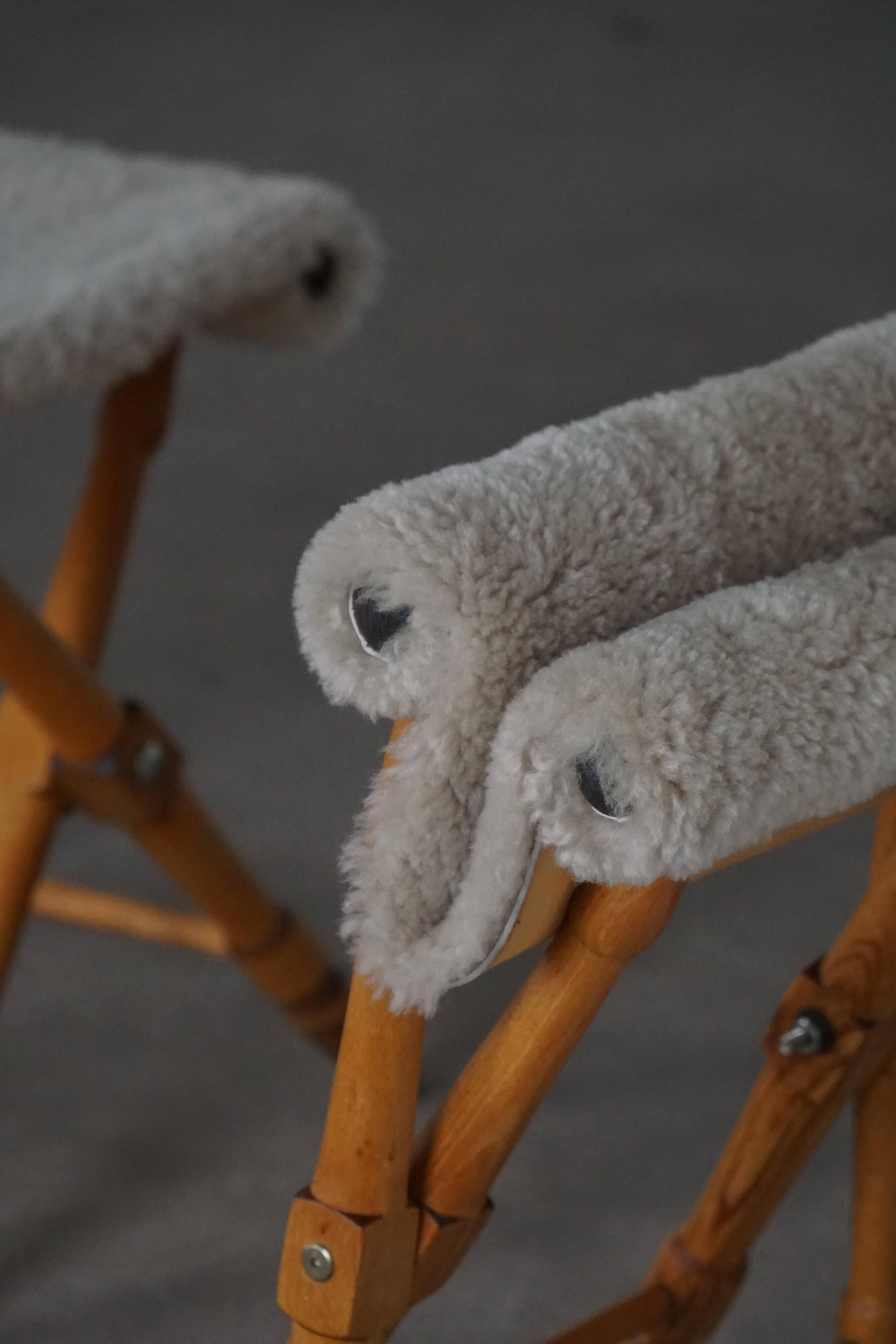 Pair of Danish mid-century folding stools with sheepskin upholstery, 1960.