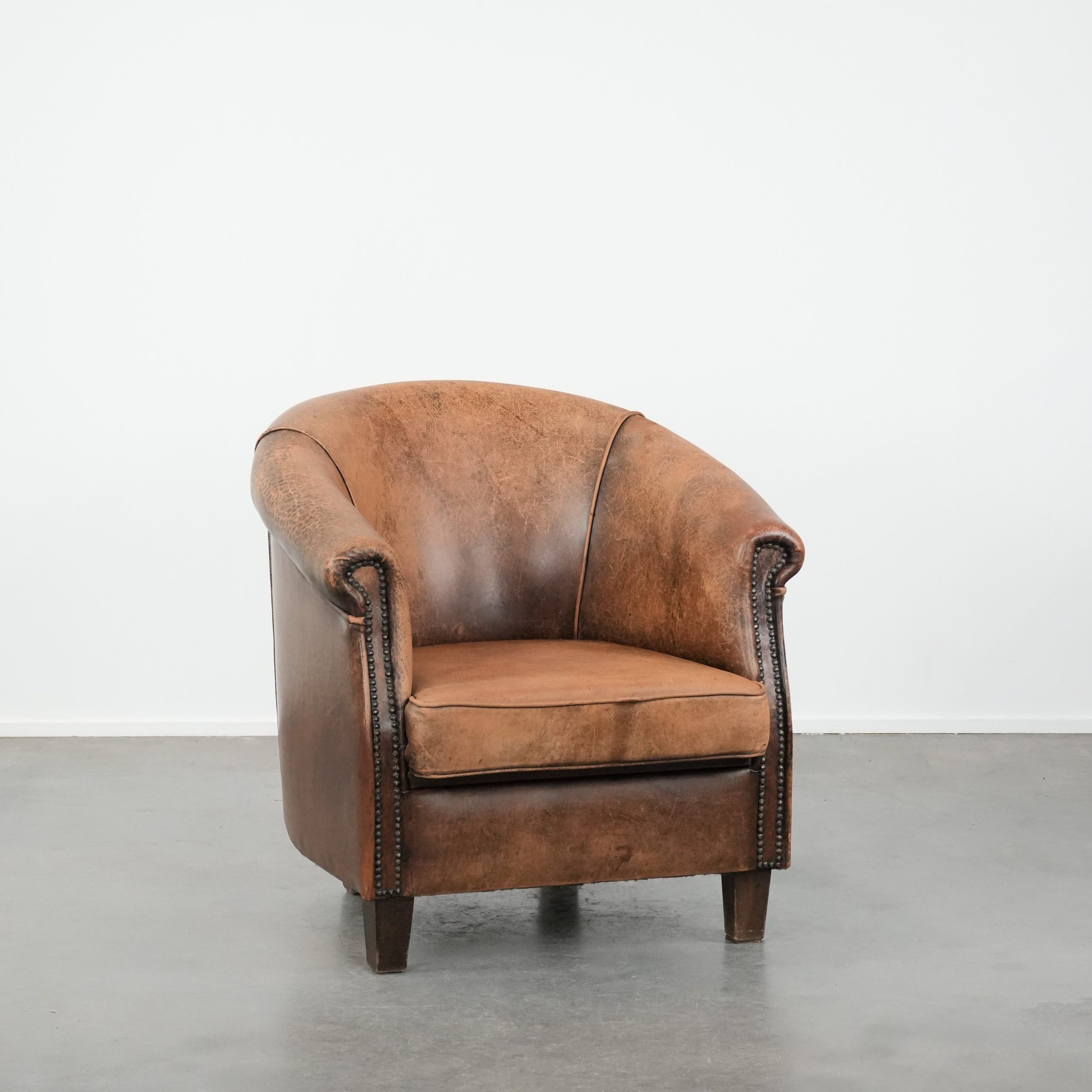 Vintage sheepskin club armchair with character and a beautiful patina
