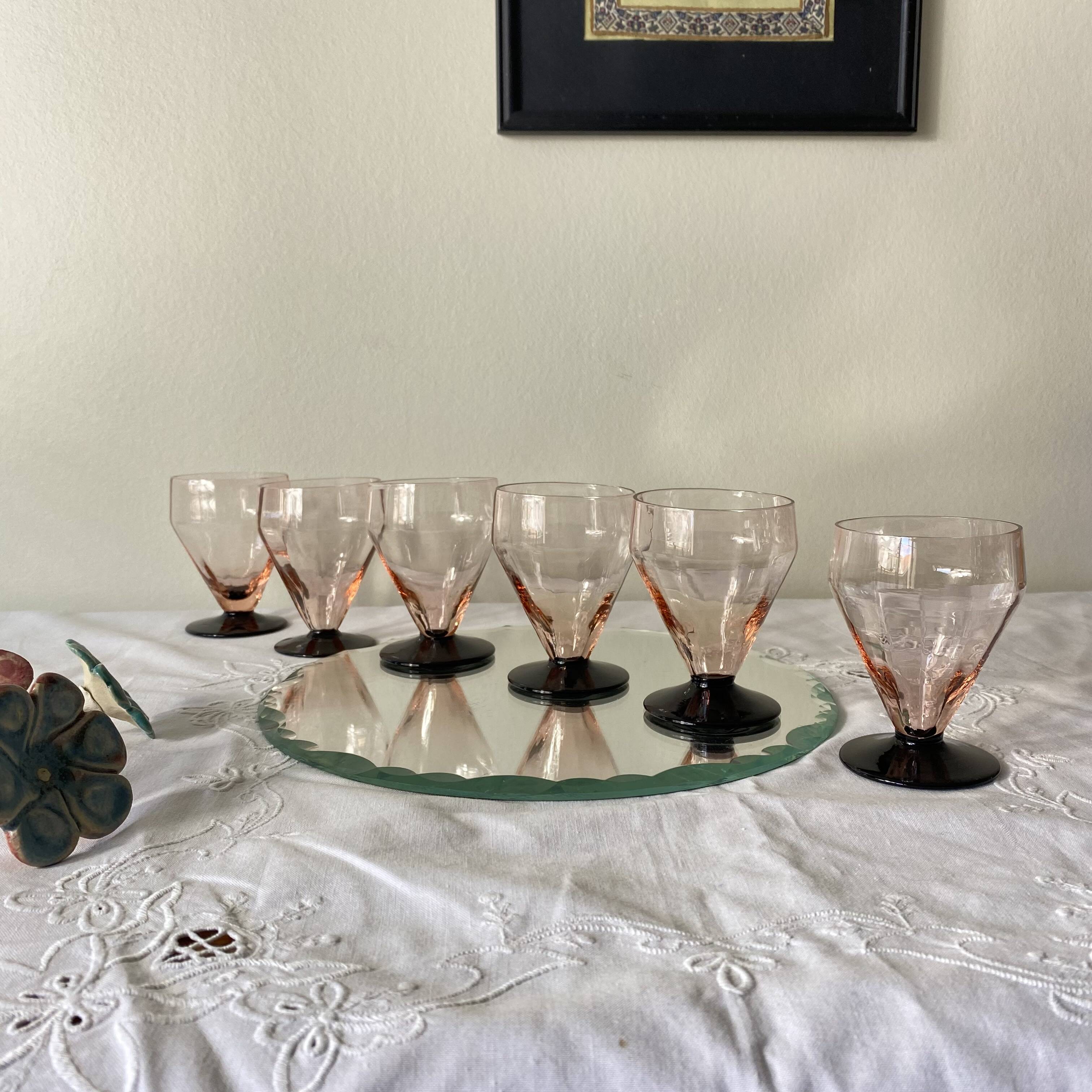 6 small Art Deco pink wine or water glasses with black stems.