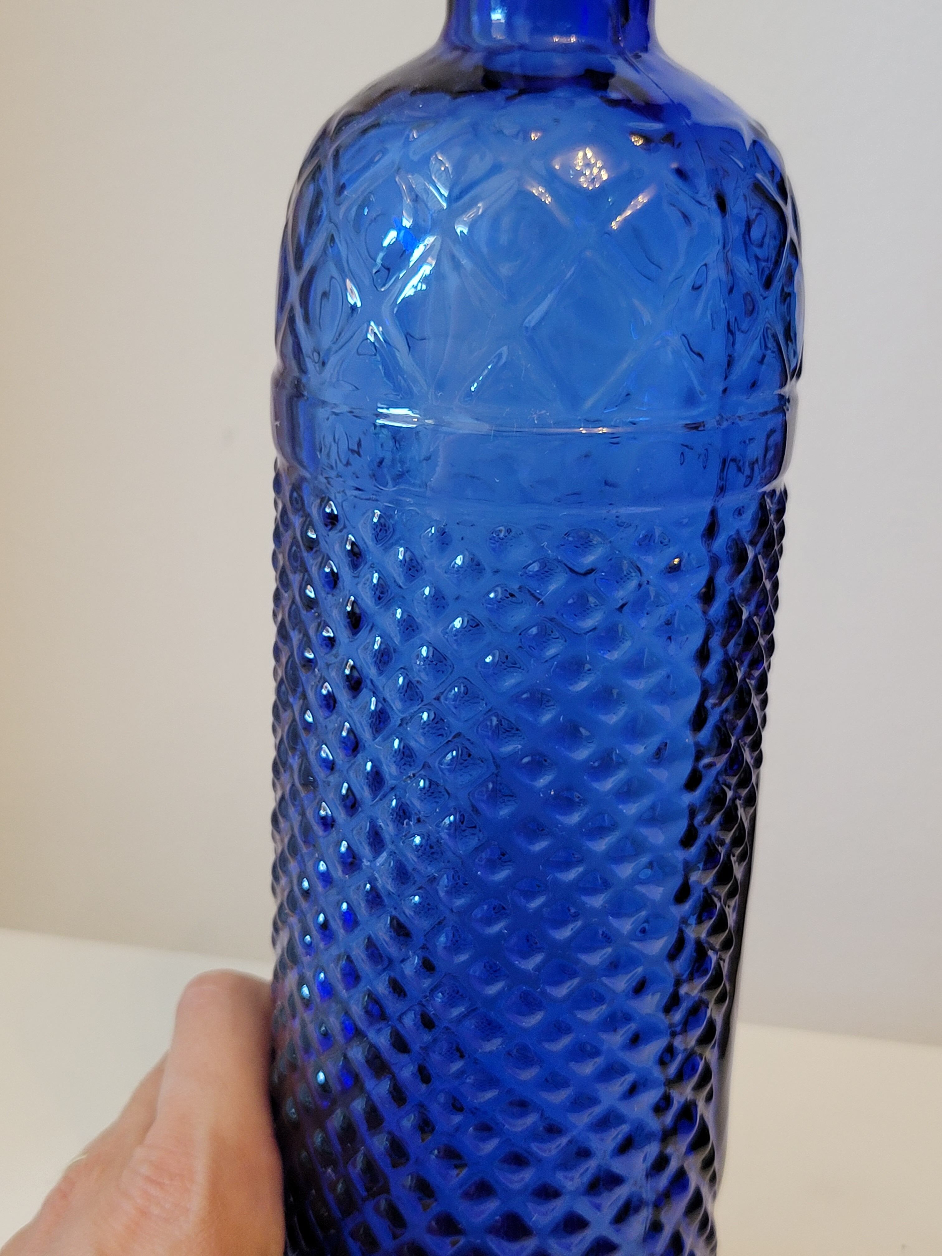 Vintage decanter bottle made of blue molded pressed glass