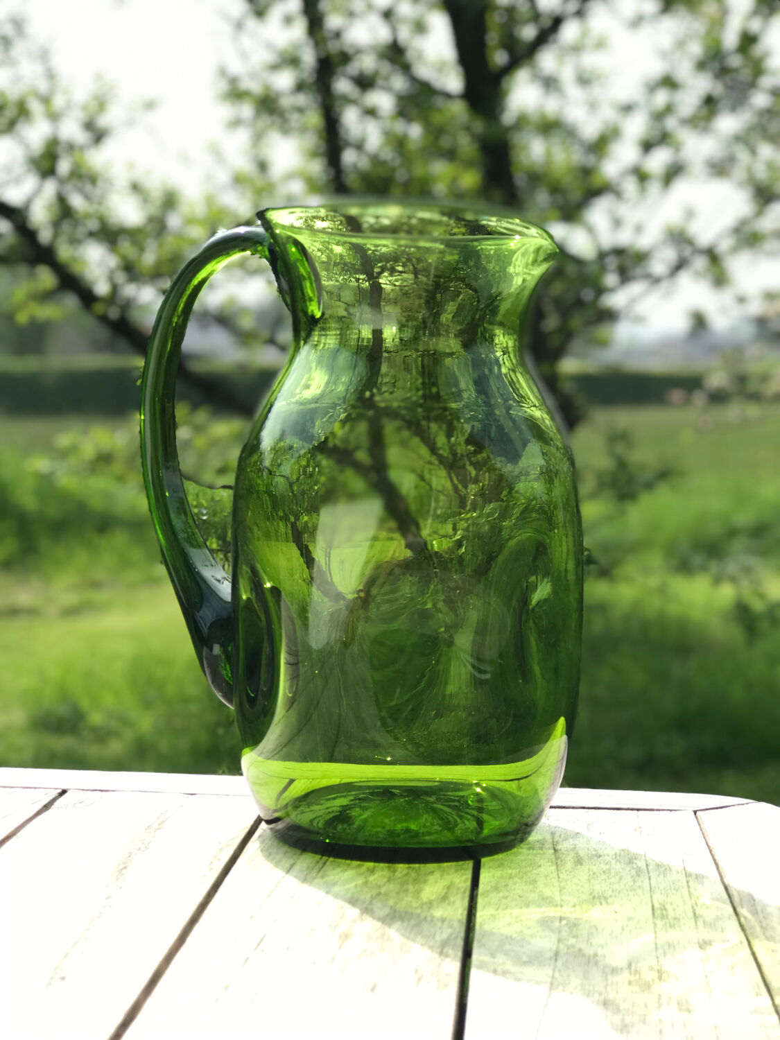 Green water jug in blown glass