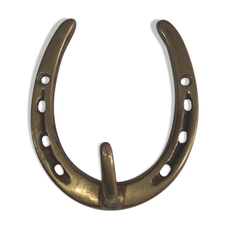 Horseshoe-shaped brass coat rack