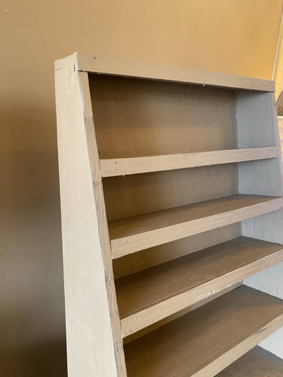 Painted wooden display shelf with an incline