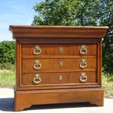 Chest of drawers with decorated handles in the Louis XVI style.