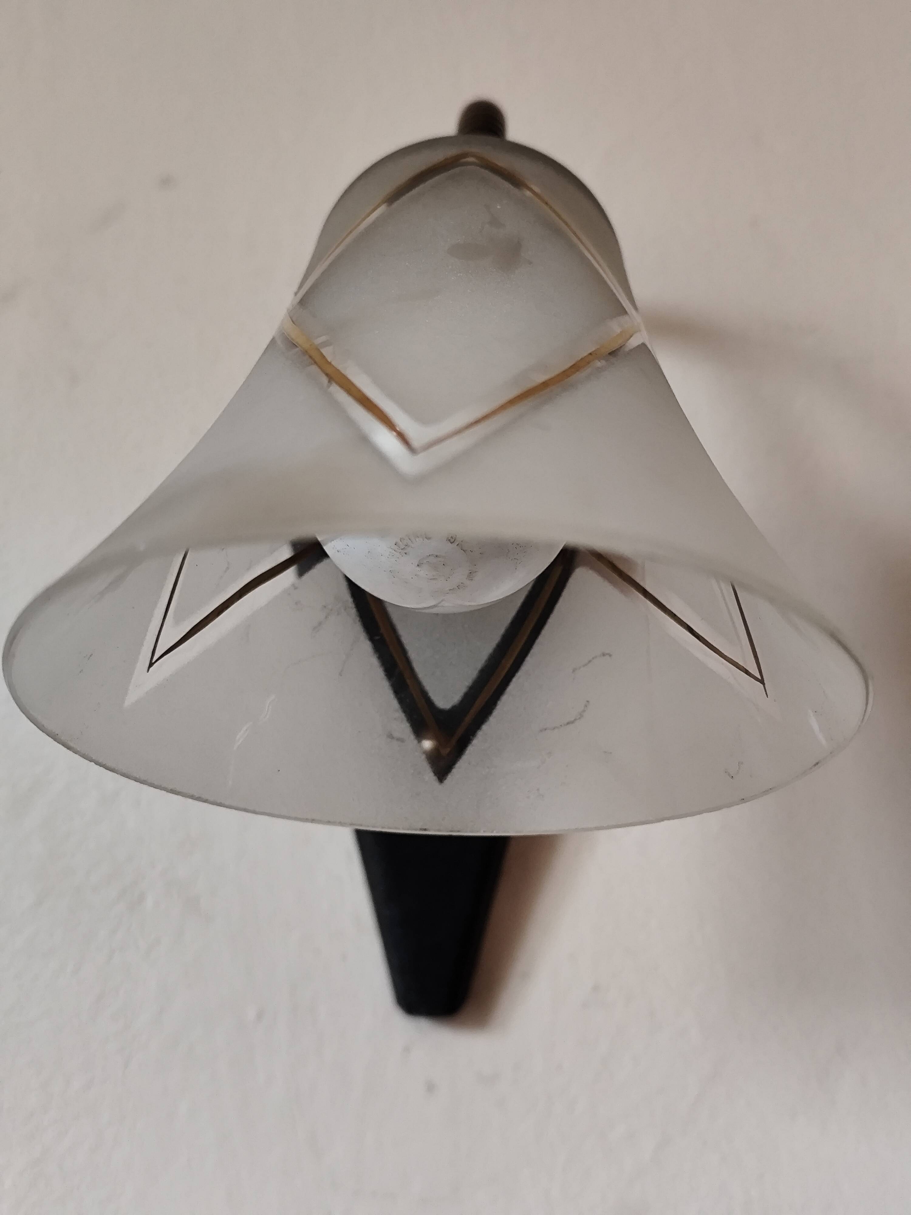 1950s wall lamp, metal, flexible brass stem and opaque shade.