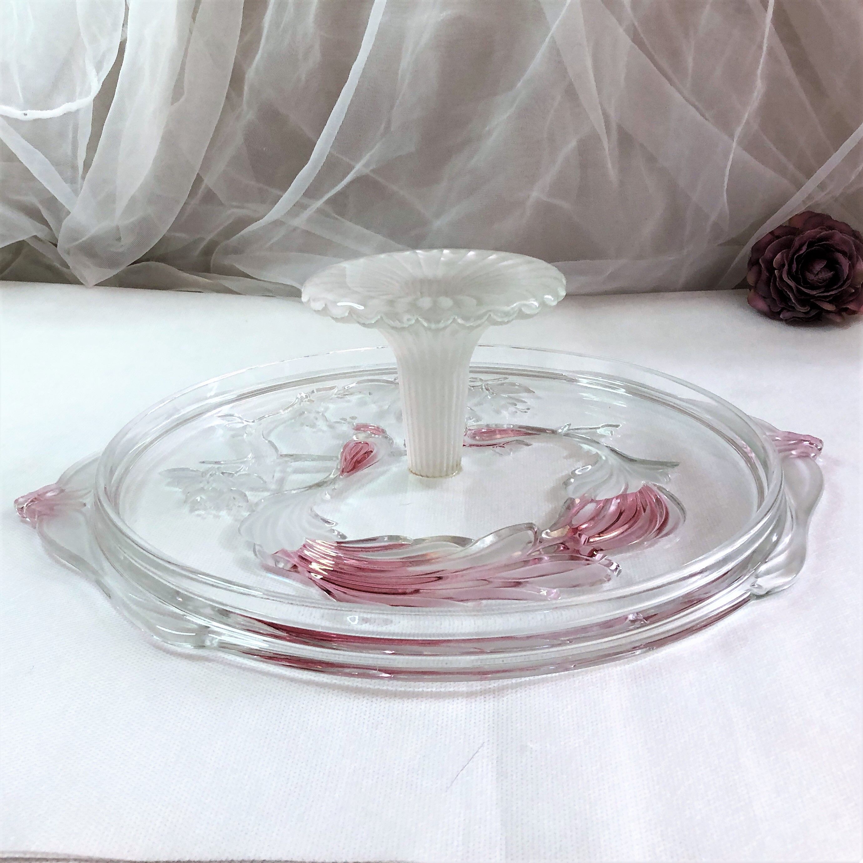 Large pie dish cakes on pedestal decorated with peacocks
