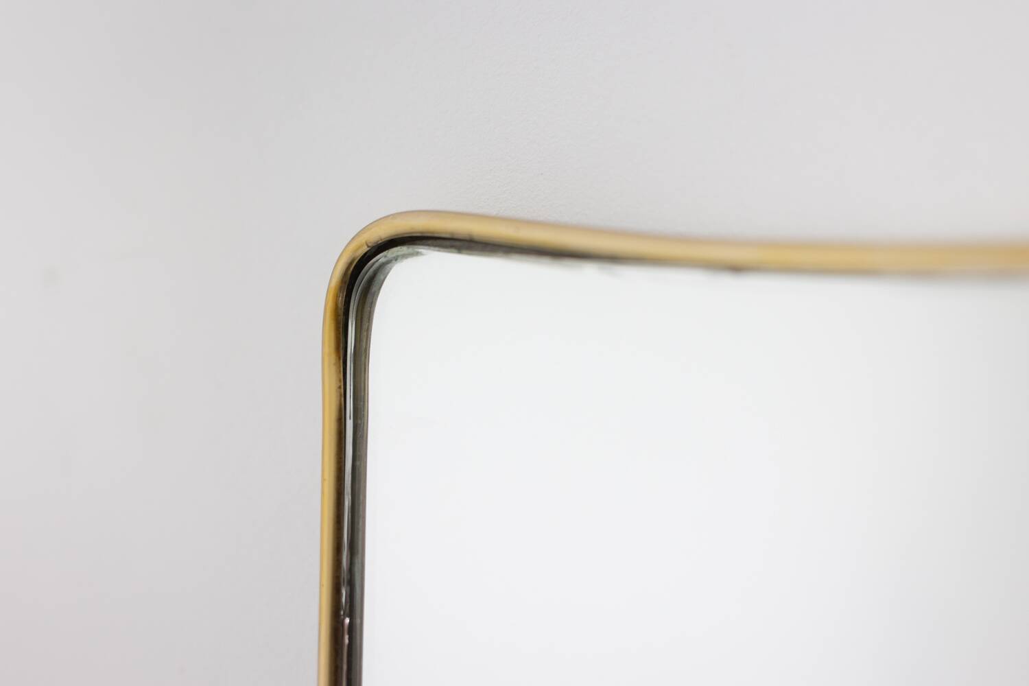 Pair of narrow gilt brass mirrors. Circa 1970.