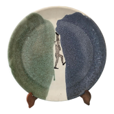 Glazed ceramic plate representation man between two lands unknown signature