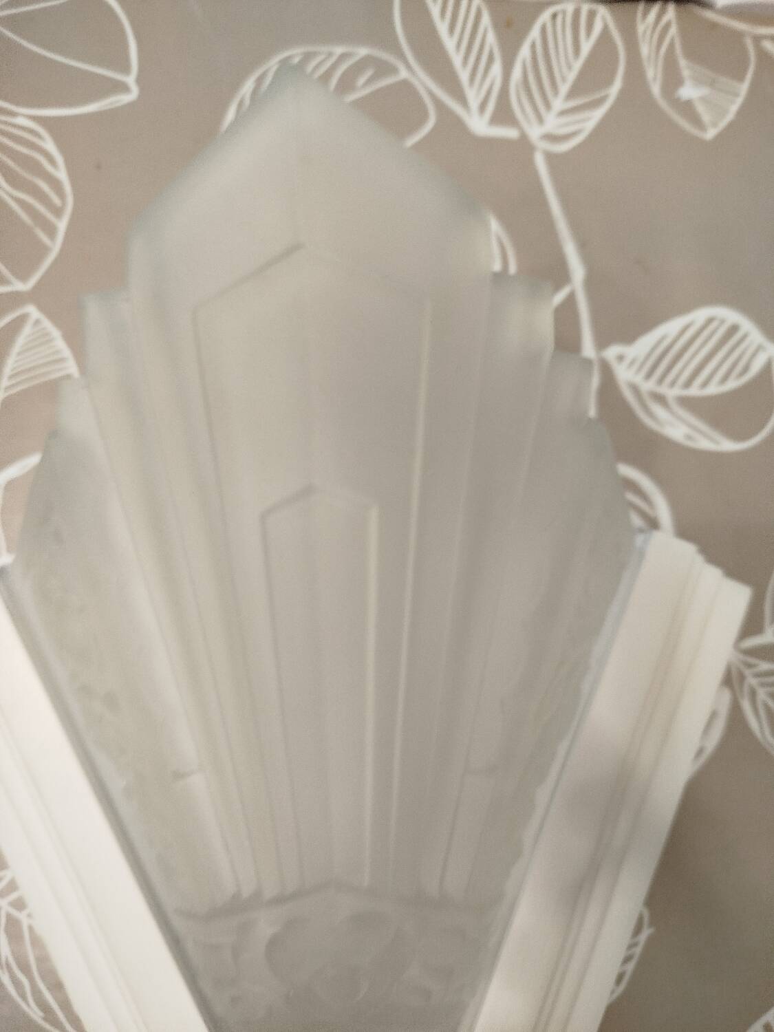 Pair of Art Deco wall sconces in plaster and pressed glass.