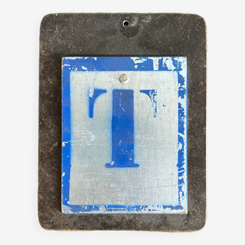 Letter T on metal plates
