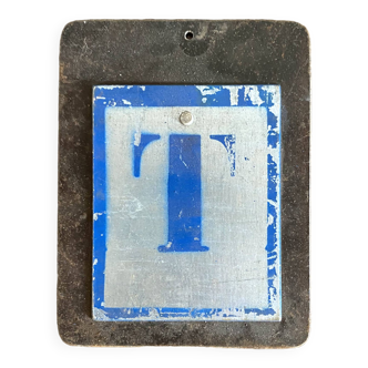 Letter T on metal plates