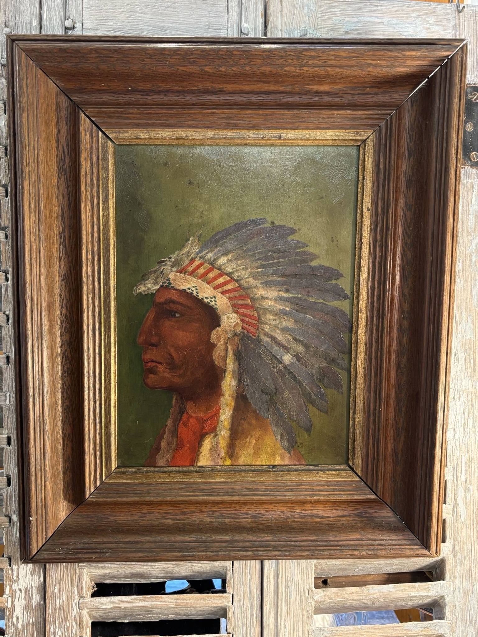 Old oil painting on panel of a Native American chief from the 19th century Wild West.