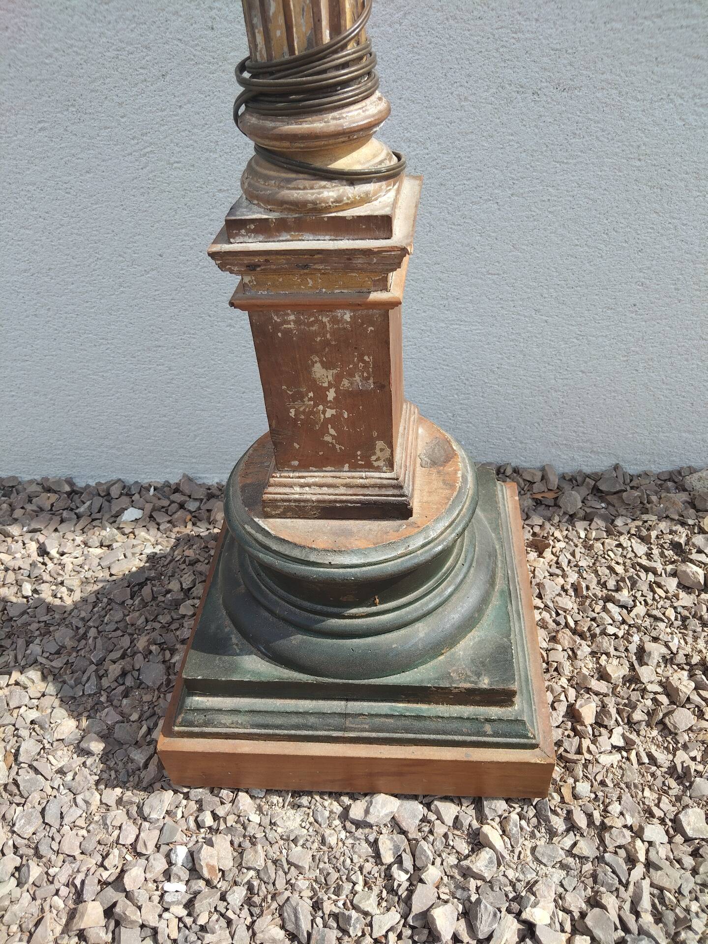 Large antique church candlestick in carved wood transformed into a lamp.