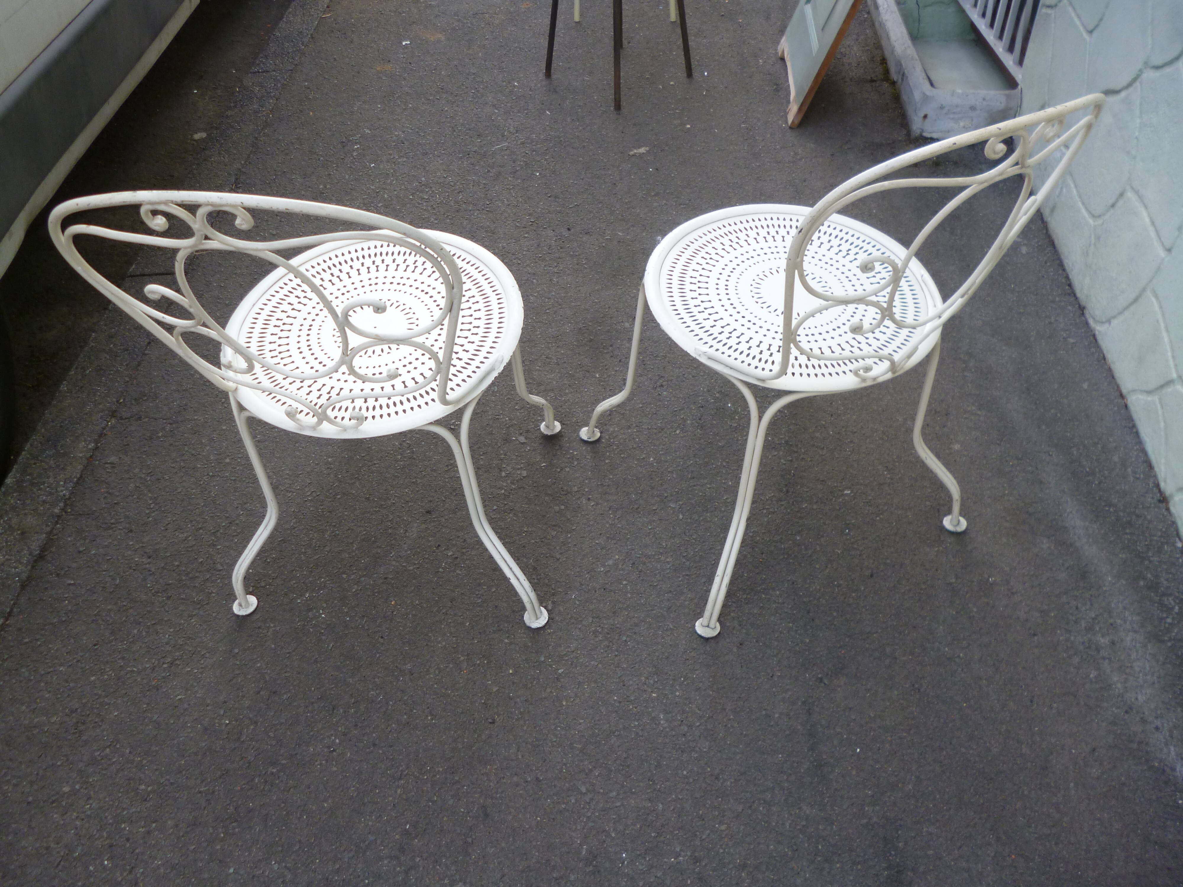 Pair of old wrought iron garden chairs