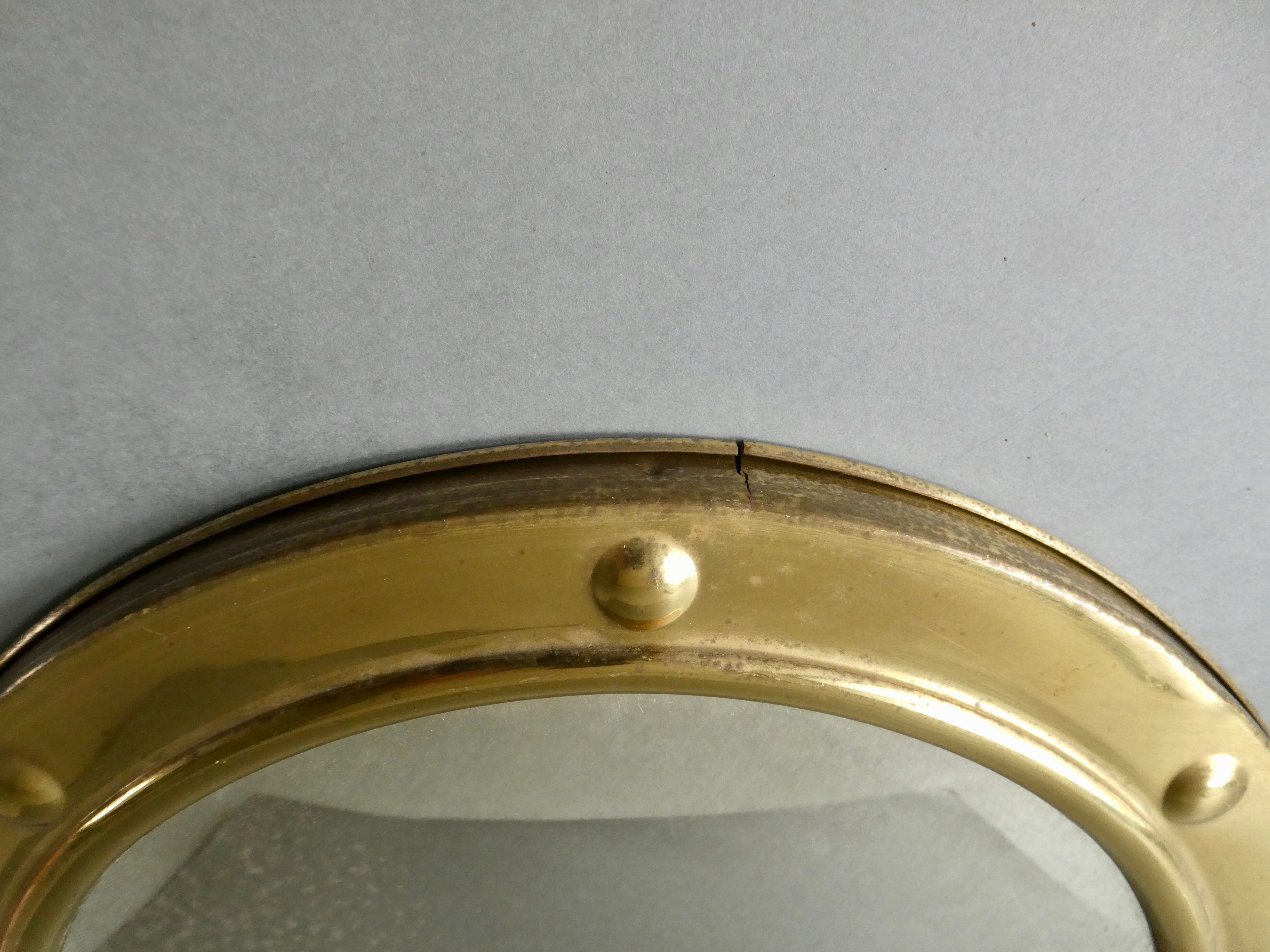 Curved mirror, in a brass porthole, 70s