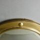 Curved mirror, in a brass porthole, 70s