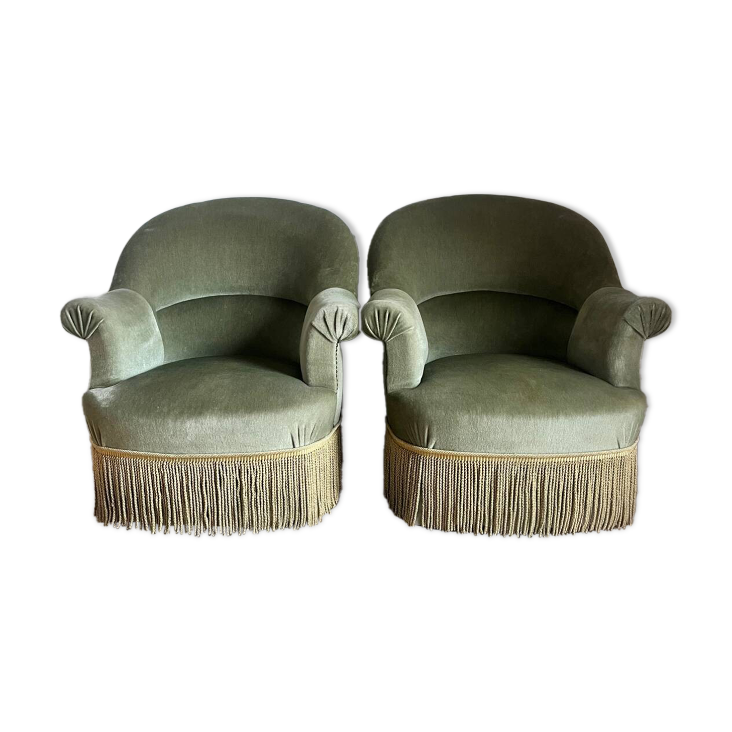 sage green toad armchairs with gold fringe