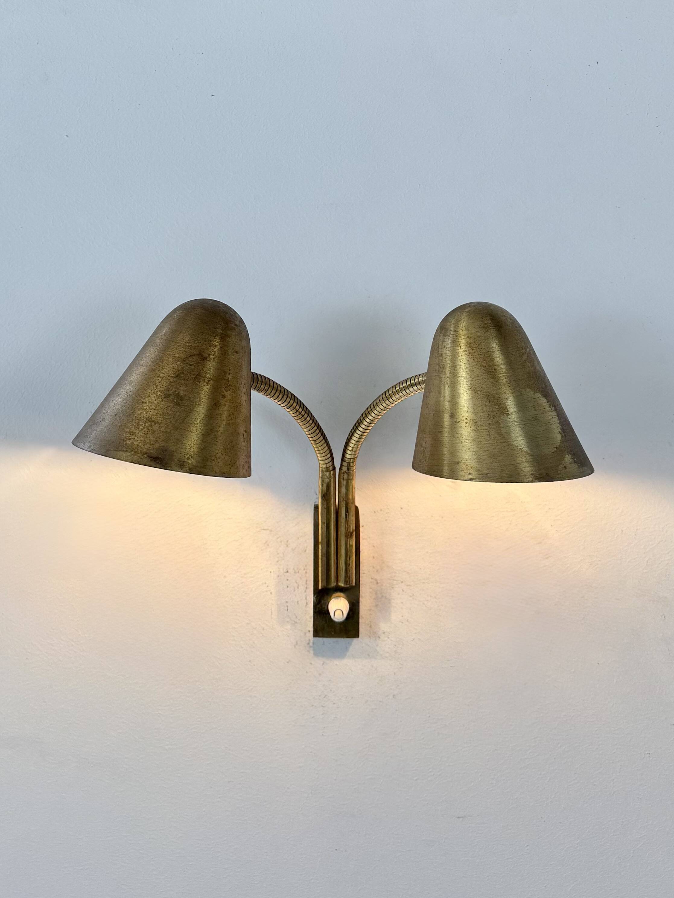 Double orientable vintage patinated brass wall light, Jacques Biny France 1950.