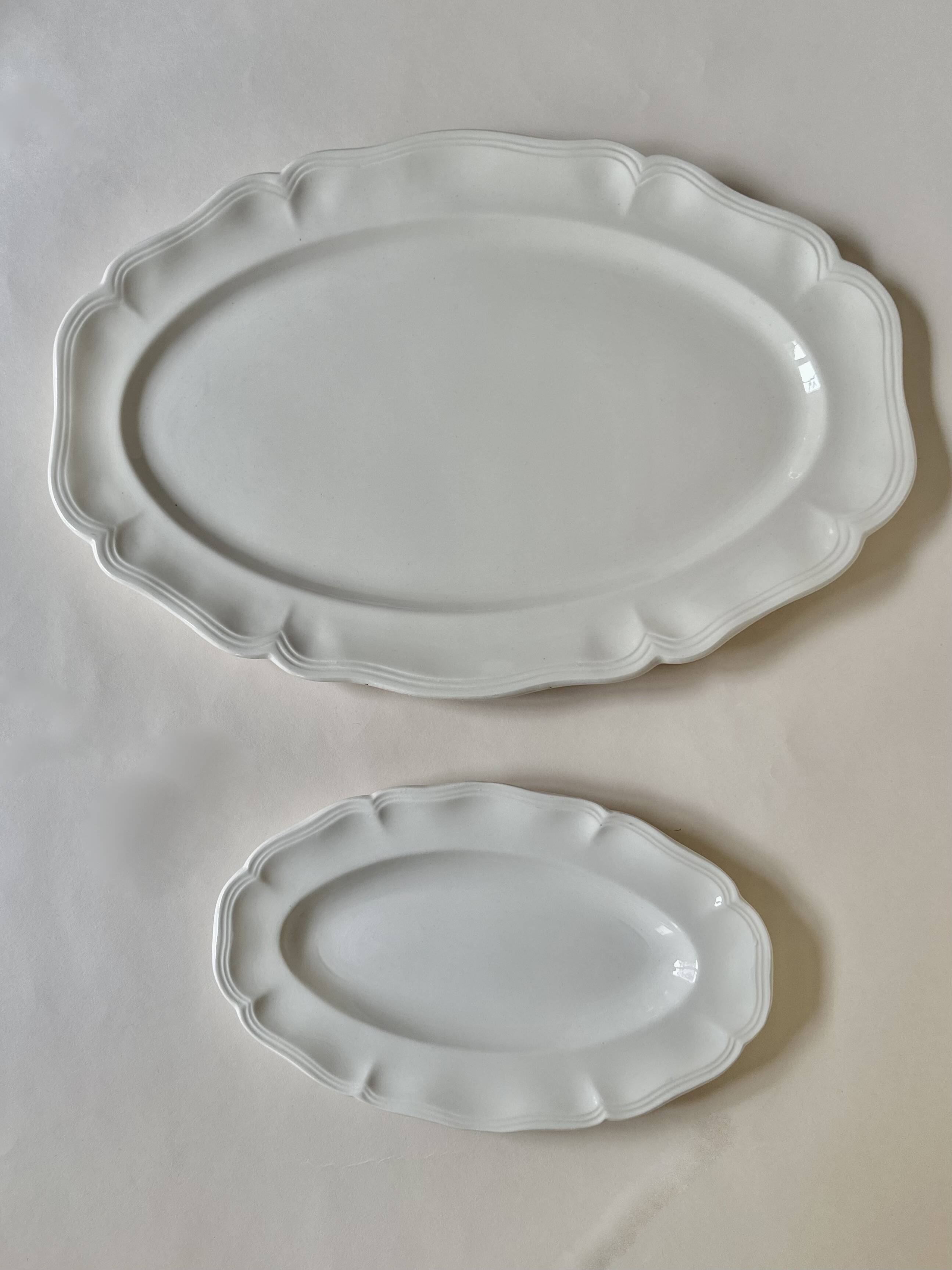 Shaped plates and dishes in Sarreguemines earthenware.