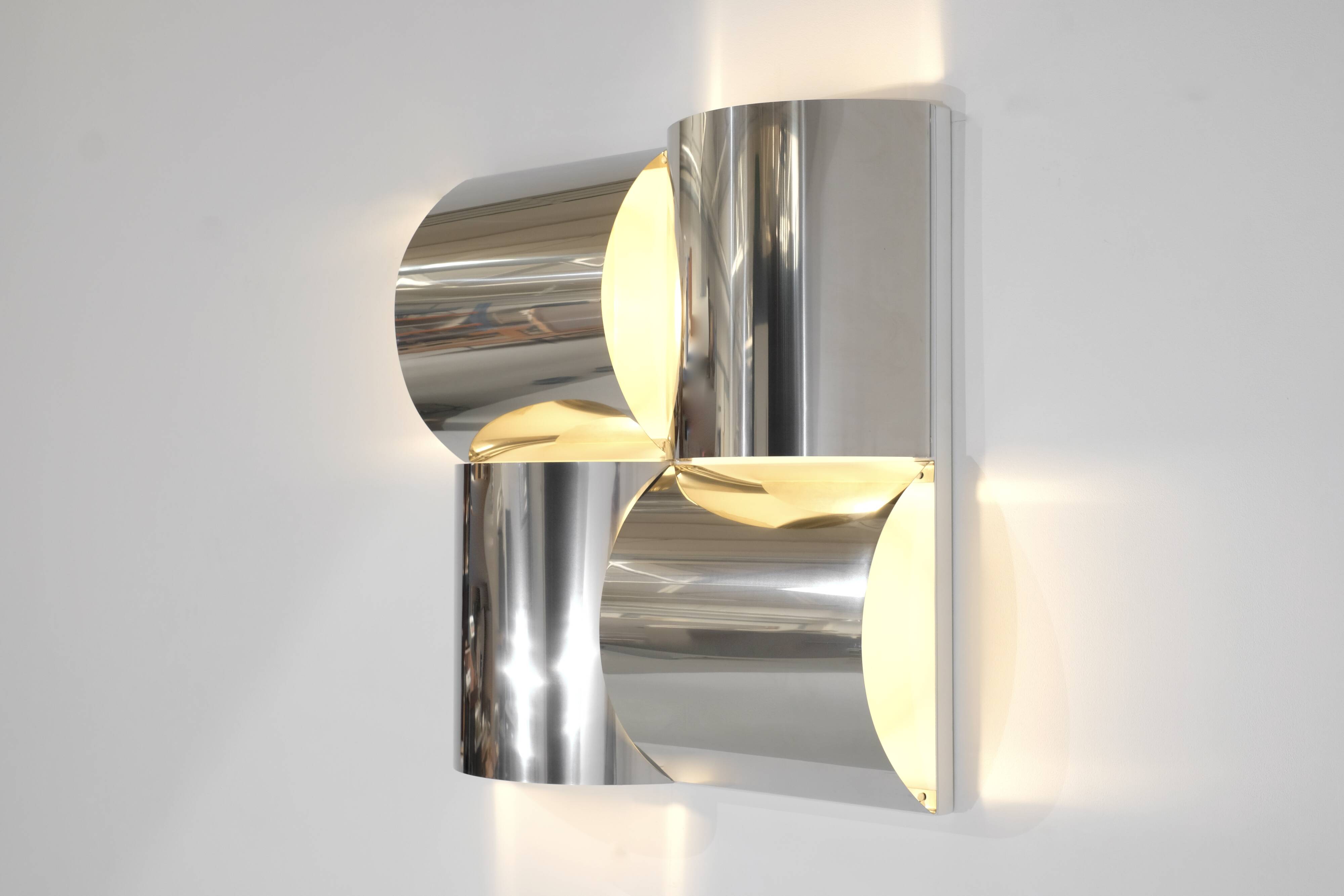 Contemporary wall light in stainless steel and metal.