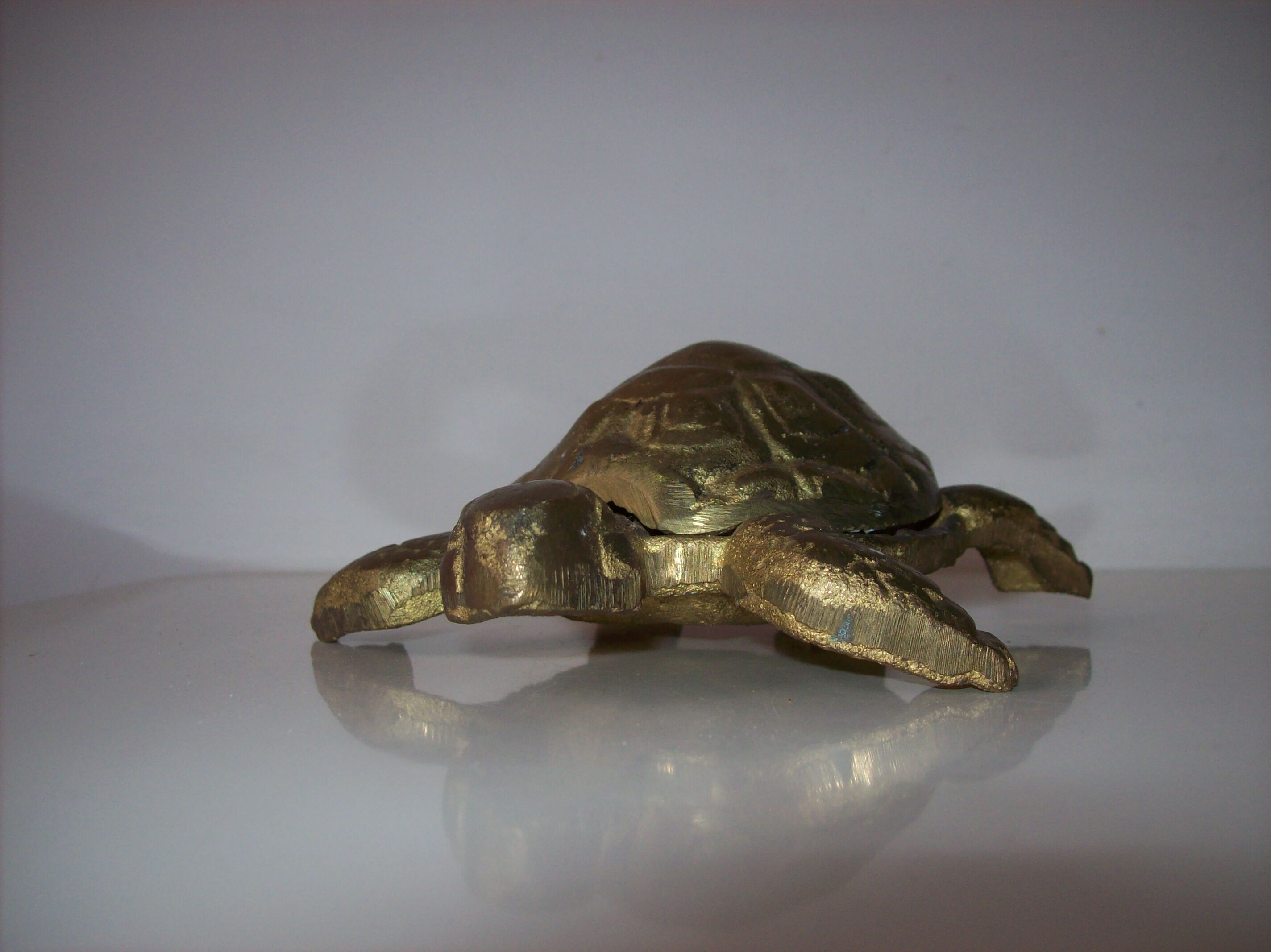 Golden brass ashtray has a turtle-shaped